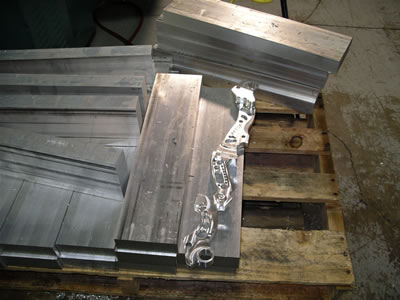 Blocks of aircraft grade aluminium prior to being made into risers and a partly finished riser